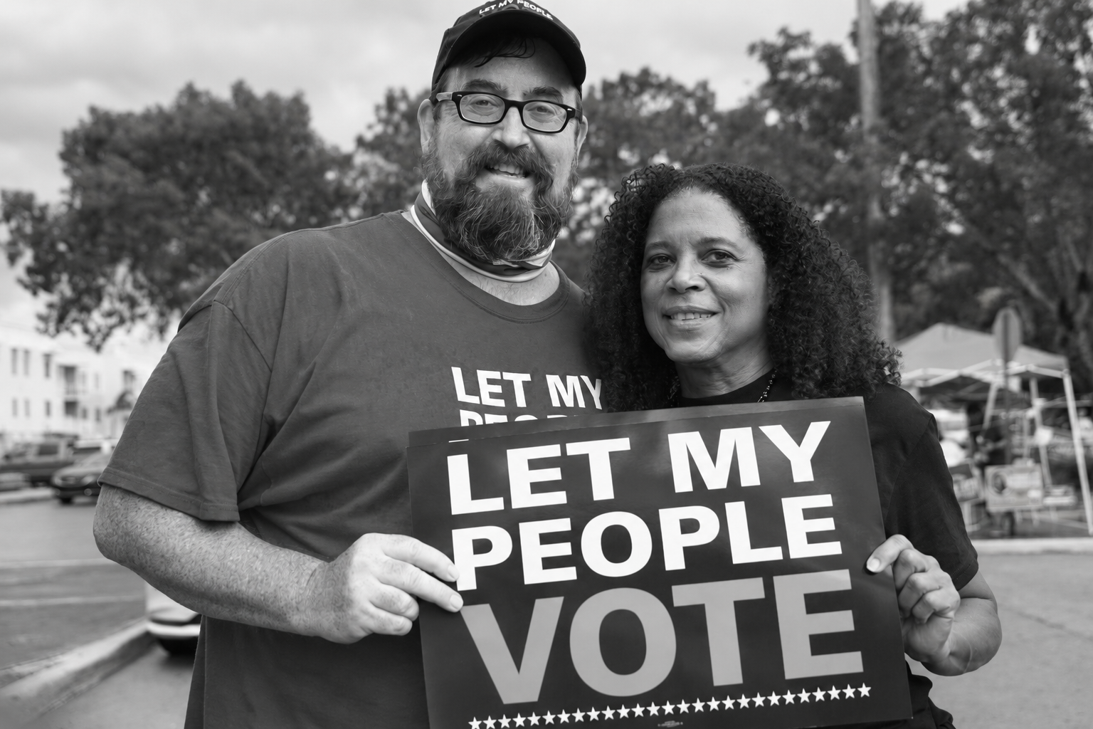 Community members standing together in support of voting rights, in black and white